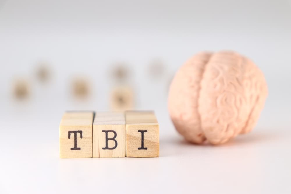 A traumatic brain injury (TBI) occurs when an external force causes brain dysfunction, often resulting from a car accident.