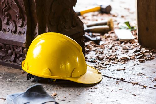 construction hat lying on ground amidst construction debris