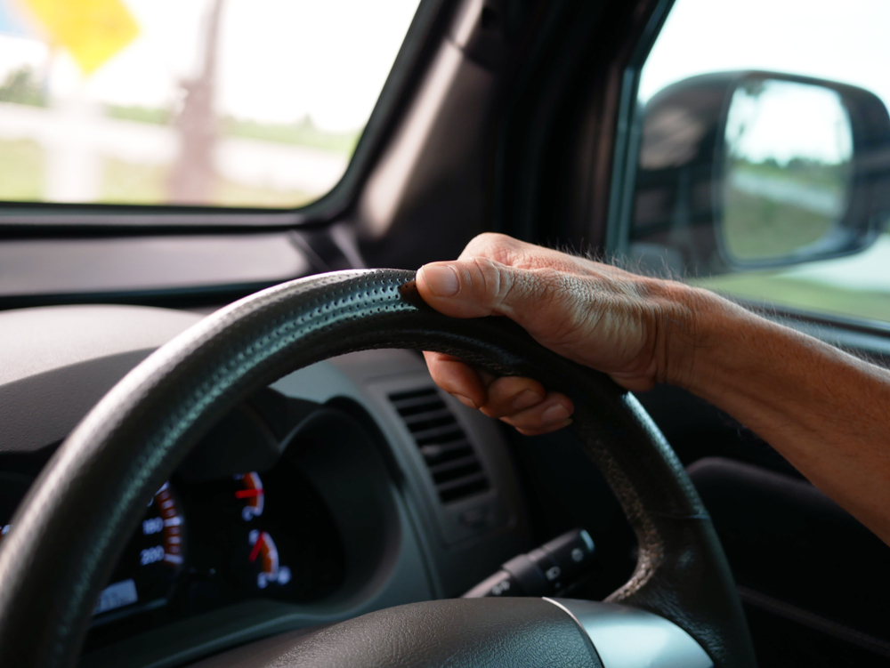 close up of hand on steering wheel