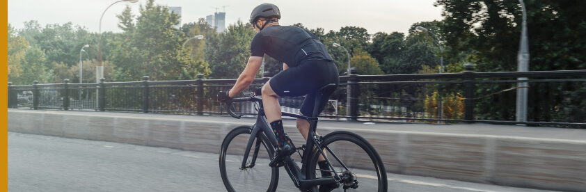 rear view of bicyclist riding on paved path