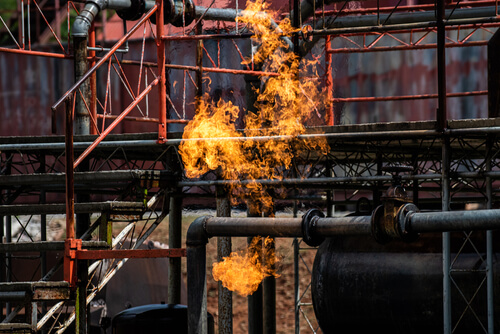 black pipes on worksite engulfed in flames