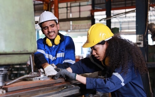 construction workers operating power machinery