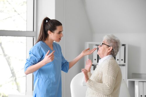 nurse aggressively confronting elderly patient