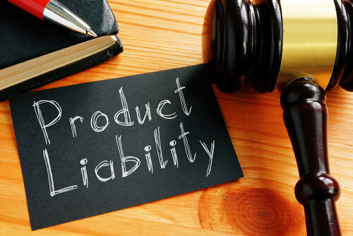 flat lay of sign reading 'product liability' on tabletop next to judge's gavel