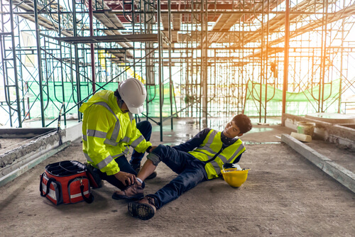 worker helping another injured worker after a scaffold fall