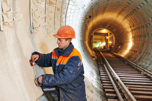 construction worker in orange hard hat working in a tunnel