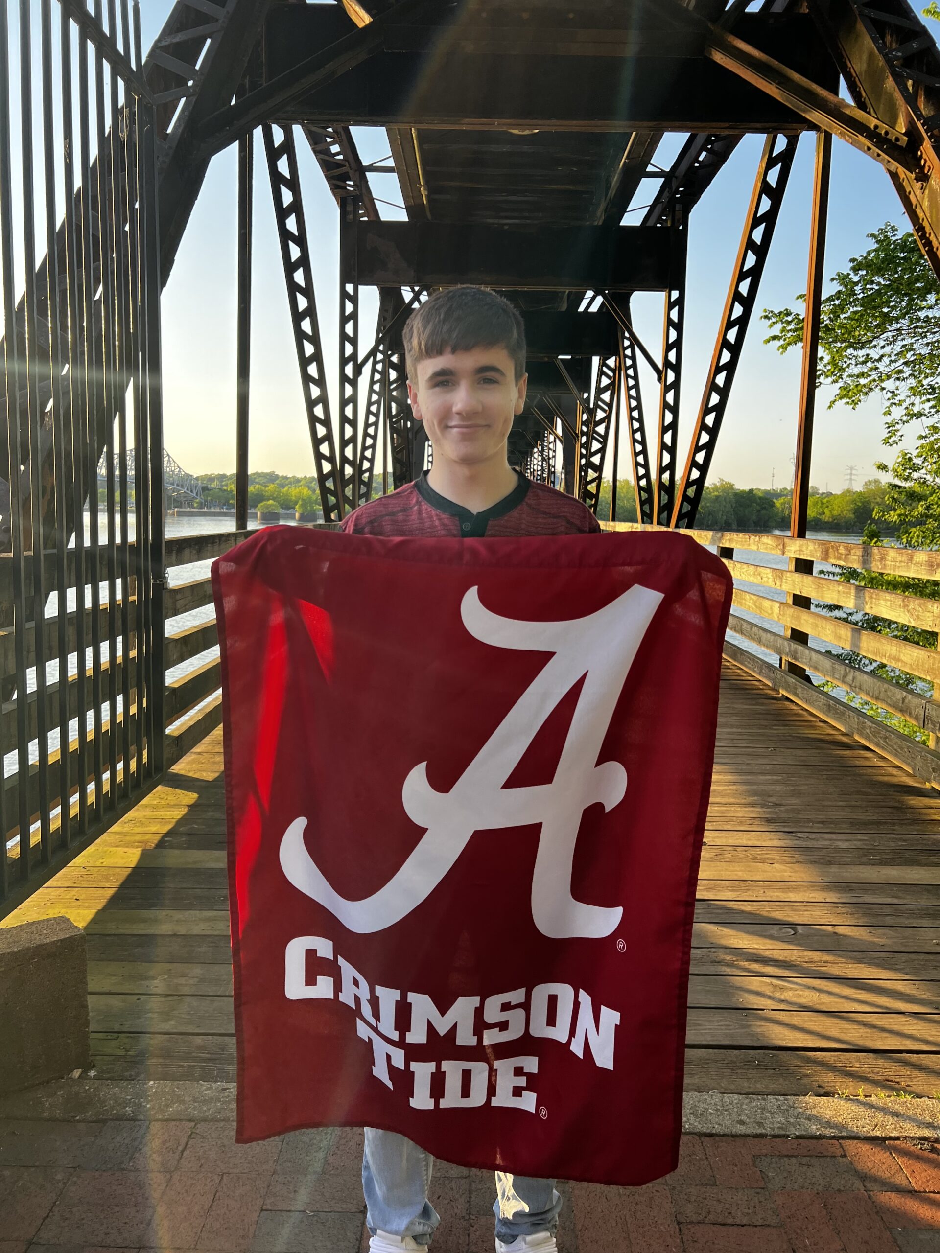 Payton Harper holding up the University of Alabama flag