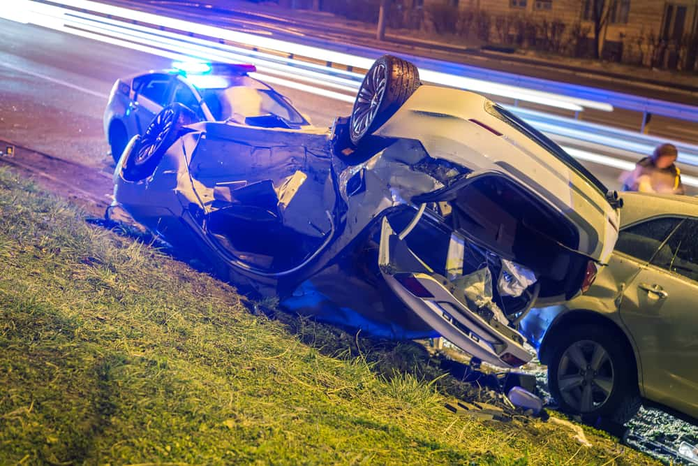 car hit by a negligent driver, in the ditch flipped on roof on NYC side road