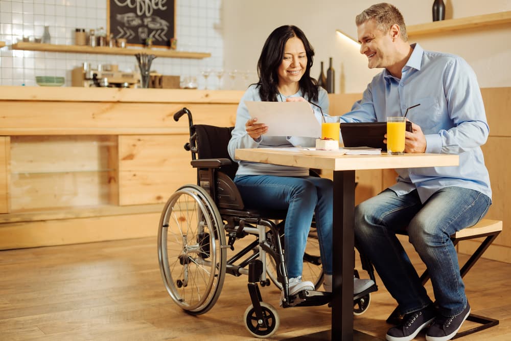 a couple looking over SSD benefits, woman in wheelchair