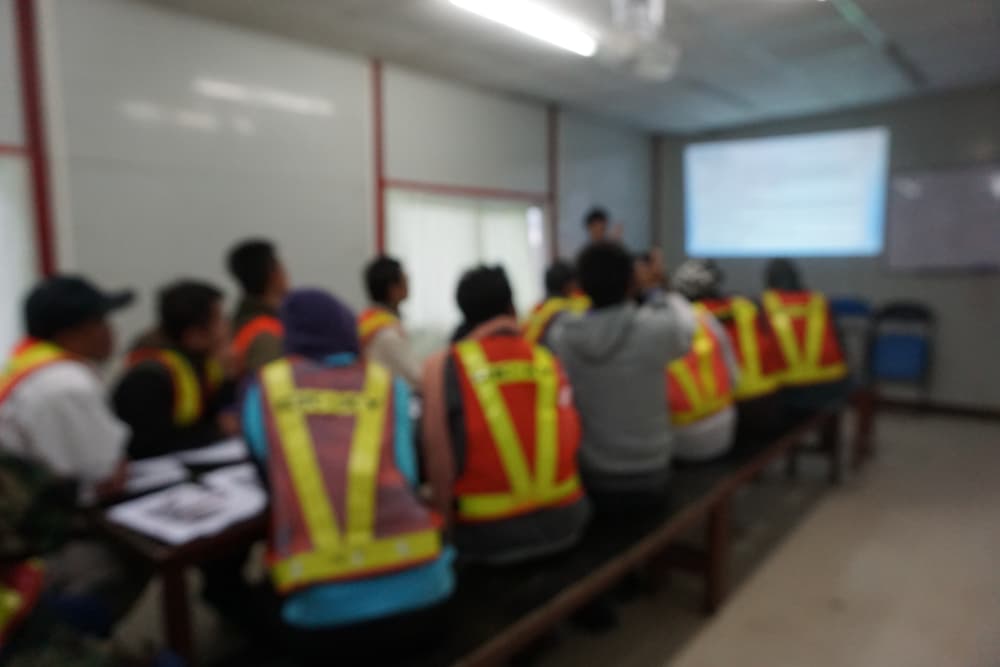 Group of construction workers at a safety meeting to ensure safety protcol is being meant to eliminate construction accidents