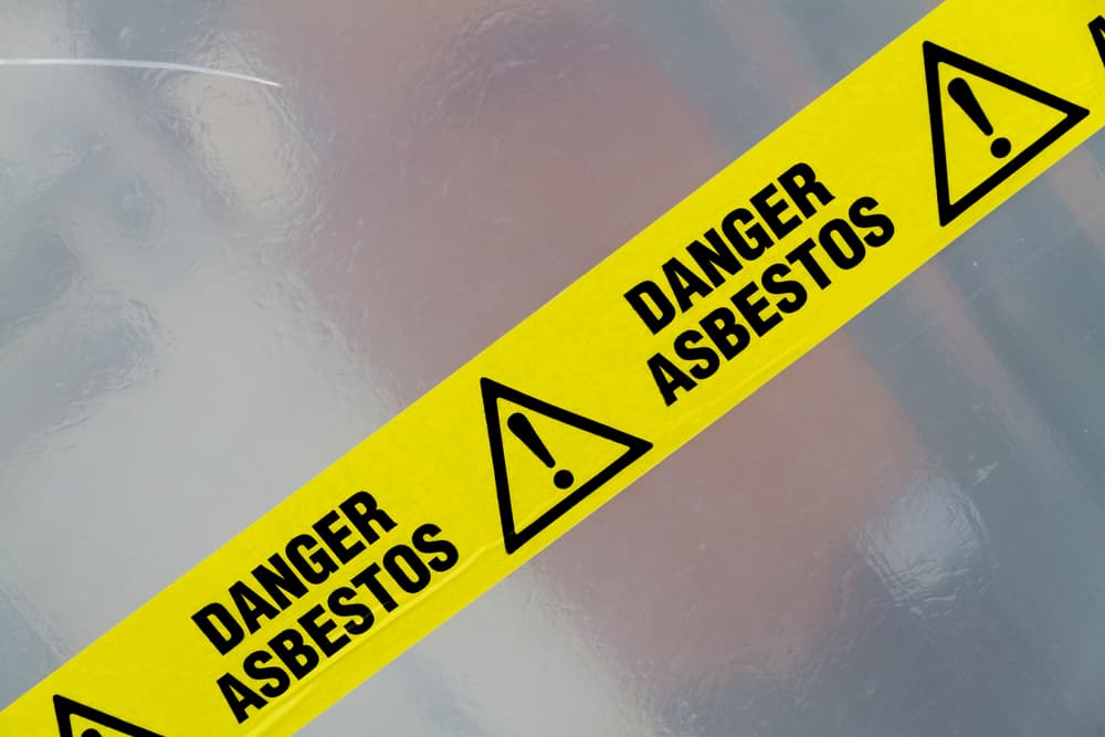 asbestos tape warning workers not to go in without proper PPE