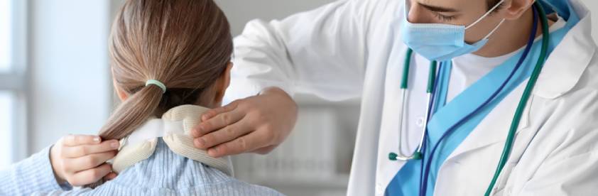 Doctor applying cervical collar on neck