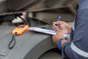 trucker reviewing paperwork with breathalyzer next to him from driving under the under influence of alcohol