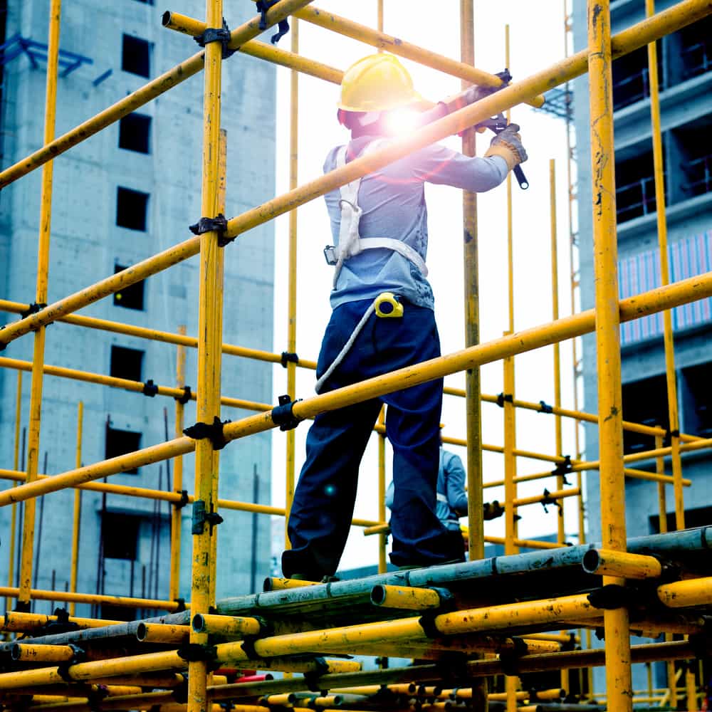 construction worker working on scaffolding at a construction site