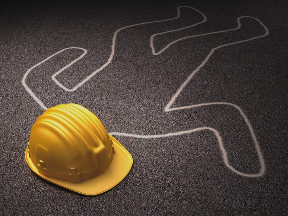 chalk outline of body with construction worker hard hat on ground