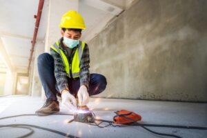 construction worker working on electrical wires with gloves on