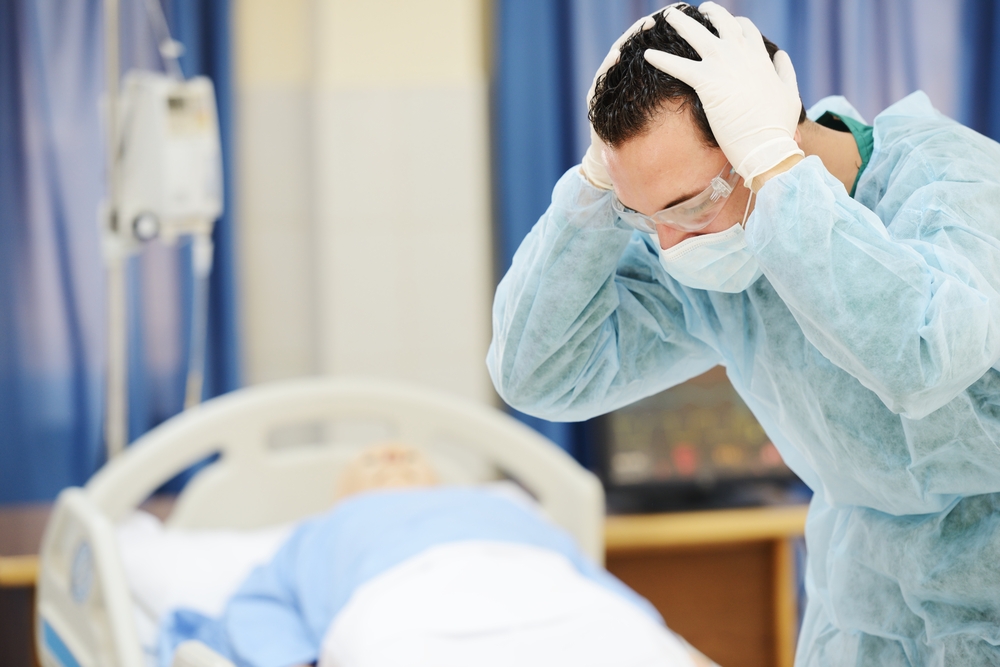 physician preoccupied of patient laying down in bed