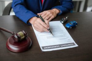 Car Accident in Staten Island A lawyer working at a table in a courtroom, with a concept of car auctions and fair legal processes in the context of selling a vehicle.