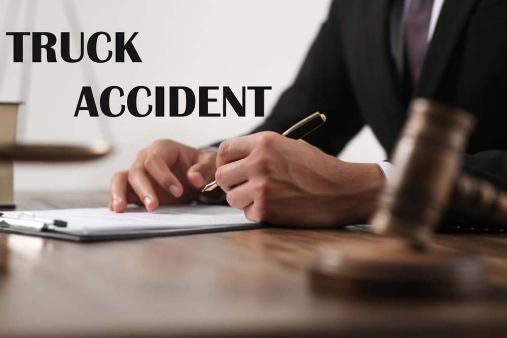 A closeup of a judge working at a wooden table on a truck accident law case. The scene includes legal documents, a gavel, and a scale of justice, symbolizing the legal process involved in resolving truck accident disputes.