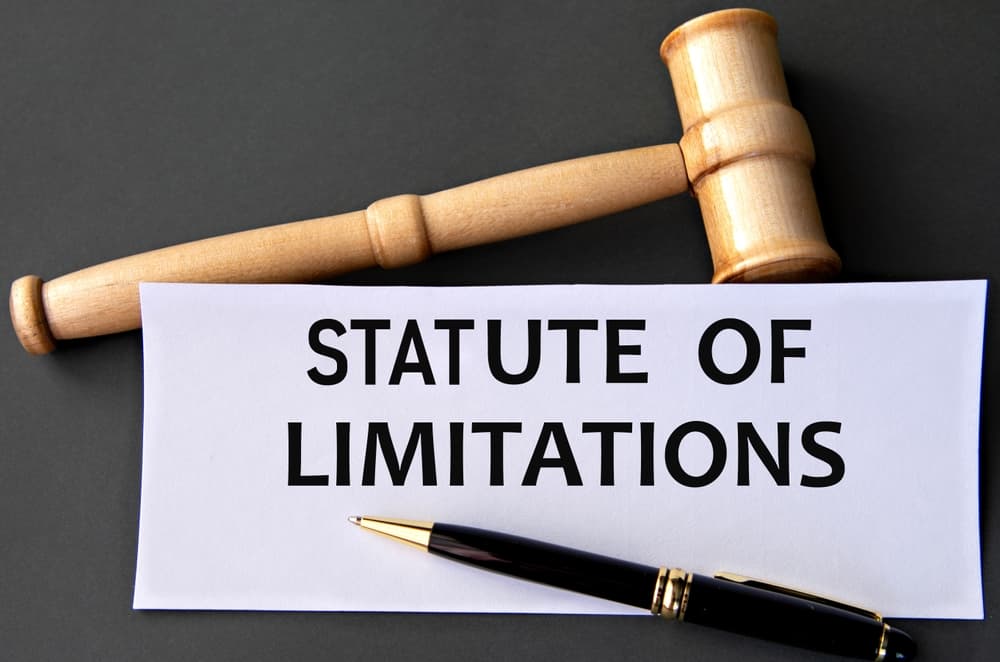 STATUTE OF LIMITATIONS - words on white paper on dark background with judge's gavel
